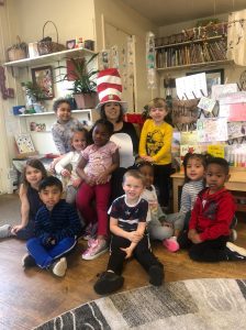 Volunteer reading Cat in the Hat to children